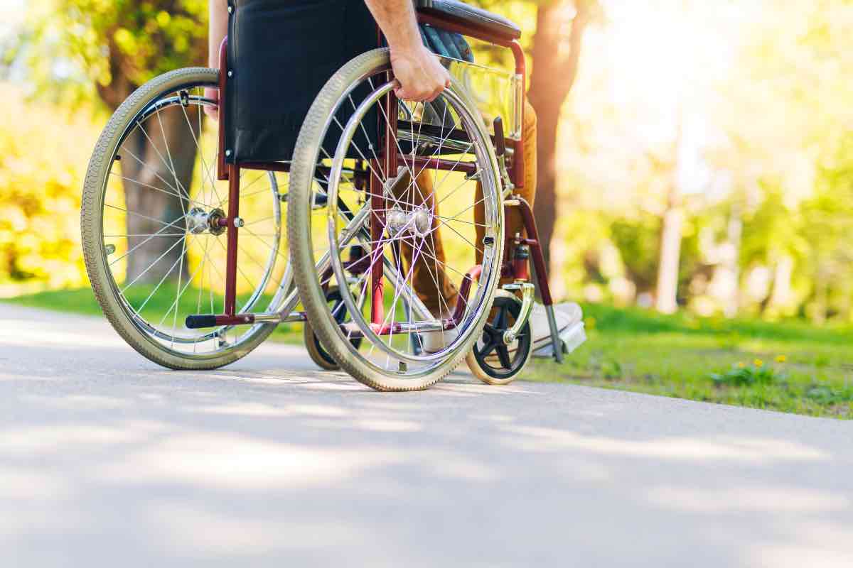 Un ragazzo in carrozzina al parco