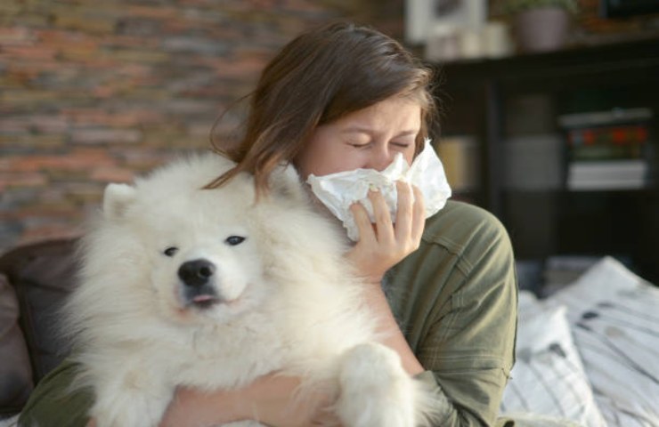 Ragazza che mostra sintomi dell'allergia ai cani